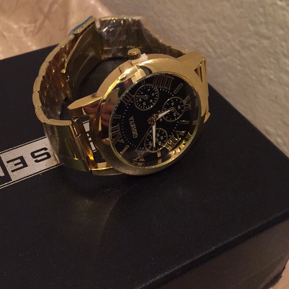 Unisex Gold and Black Geneva watch.